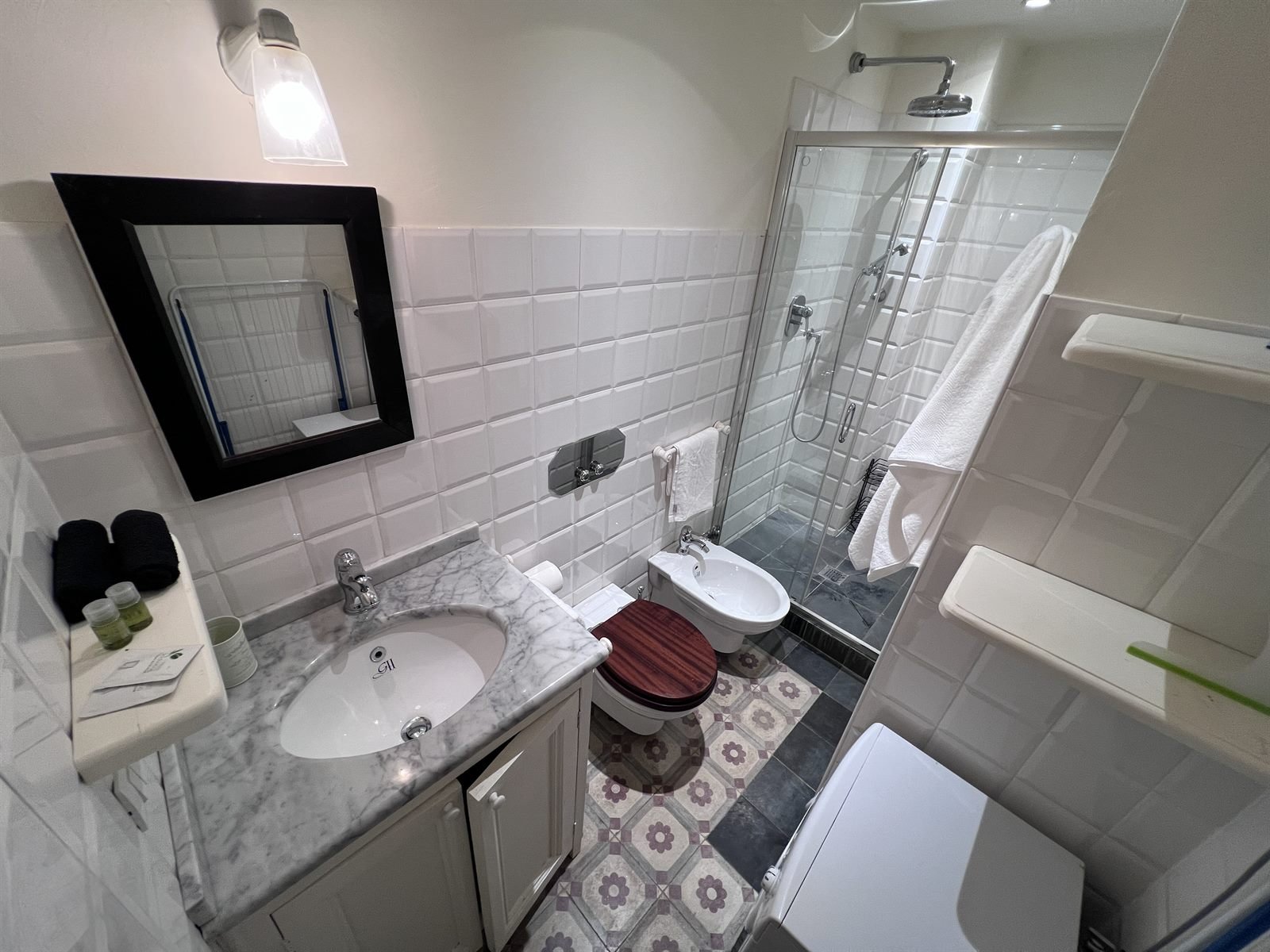 Bagno con lavabo in marmo e doccia walk-in